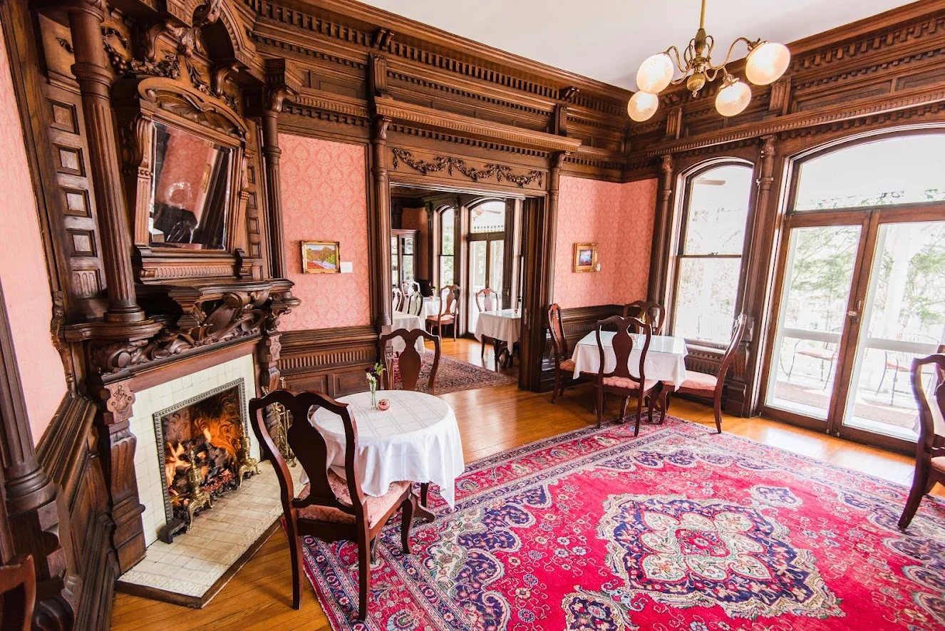 Historic wood staircase and Victorian architecture inside Cedar Crest Inn Asheville