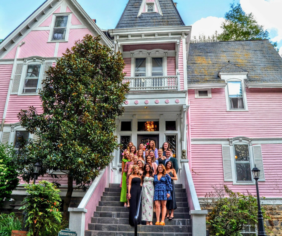 a group of bridesmiads standing around the bride infront of the historic cedar crest inn